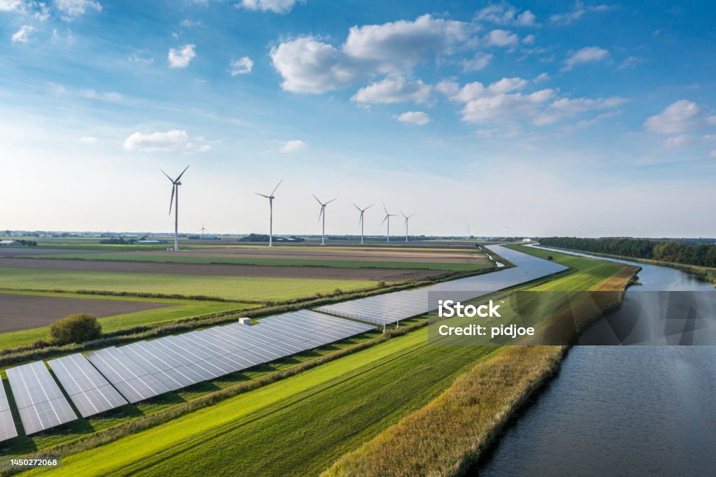 Solar panels and wind turbines generating renewable energy for green and sustainable future.